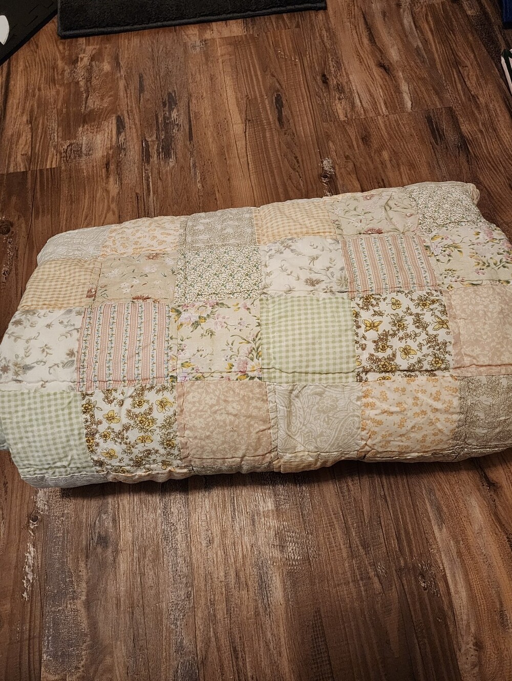 Handmade patchwork quilt with pastel floral fabric